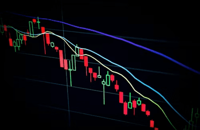 Desk with reports, magnifying glass, and trading charts